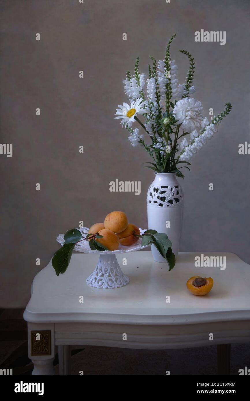 Still life with beautiful bouquet of flowers and fruits Stock Photo - Alamy