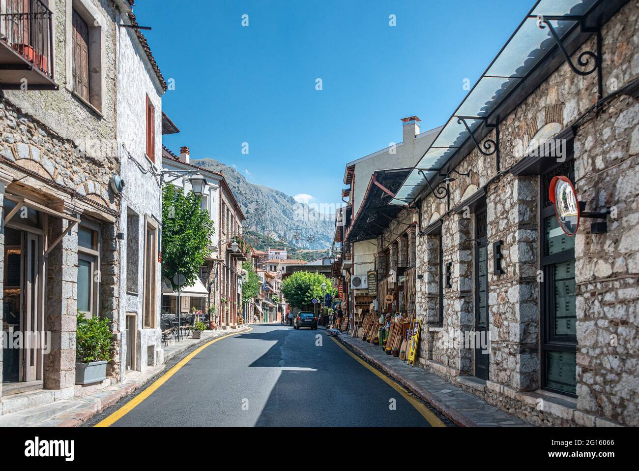Cobbled alley and stone houses in the mountain town of Arachova at the foot of Mount Parnassos in Viotia, Greece Stock Photo