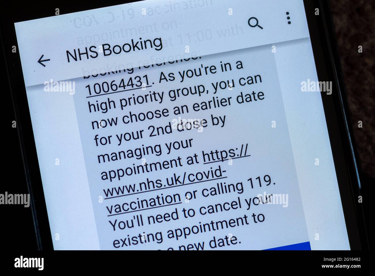 Text message from NHS advising to book an earlier appointment for 2nd covid vaccination as in high priority group (over 50 years old), UK, June 2021 Stock Photo