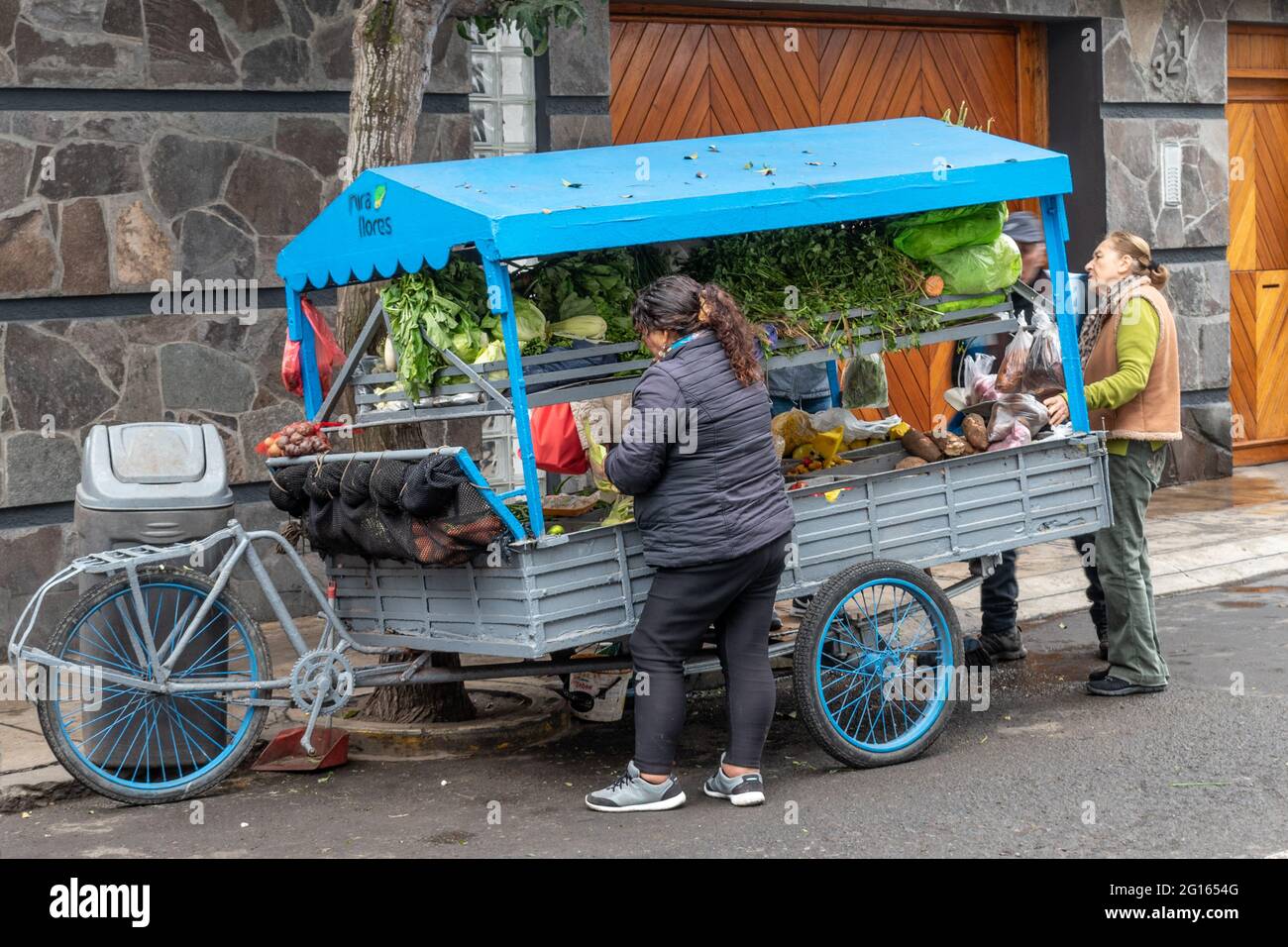 Local residents buying fruit and vegetables from a mobile vendor in Miraflores, Lima, Peru Stock Photo