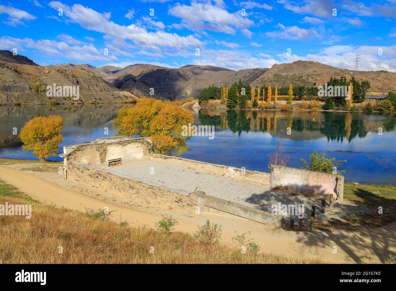 Autumn landscape in Cromwell, New Zealand. The ruins of the old Athenaeum Hall (1874) lie on the edge of Lake Dunstan Stock Photo