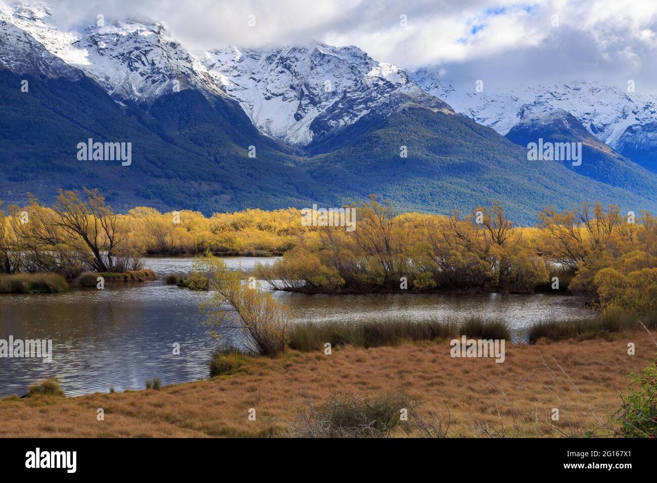 The Glenorchy Lagoon, a wetland area in the South Island of New Zealand, with autumn color. In the background are the Southern Alps Stock Photo
