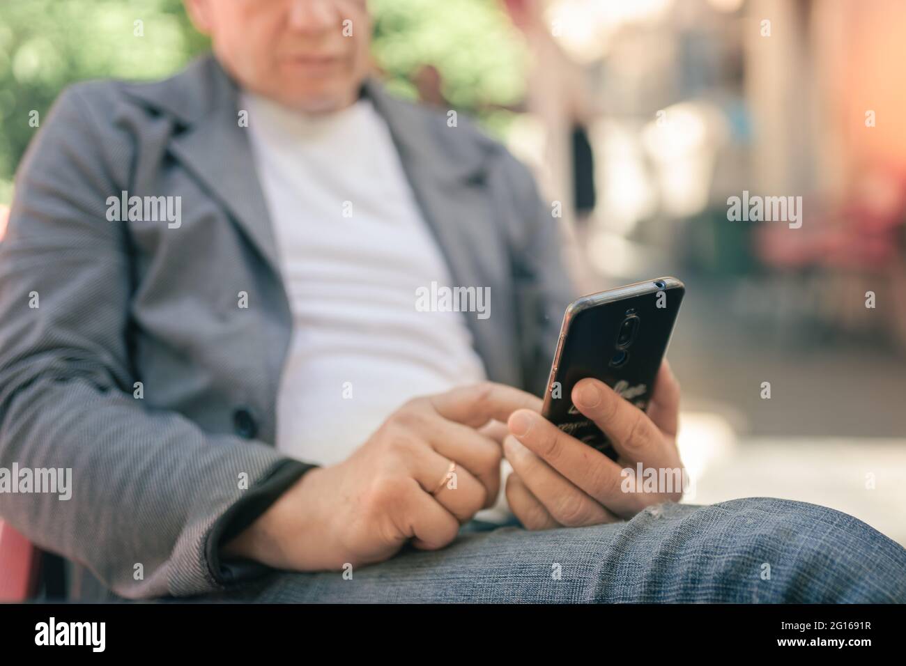 A man uses a smartphone and sends a message Stock Photo