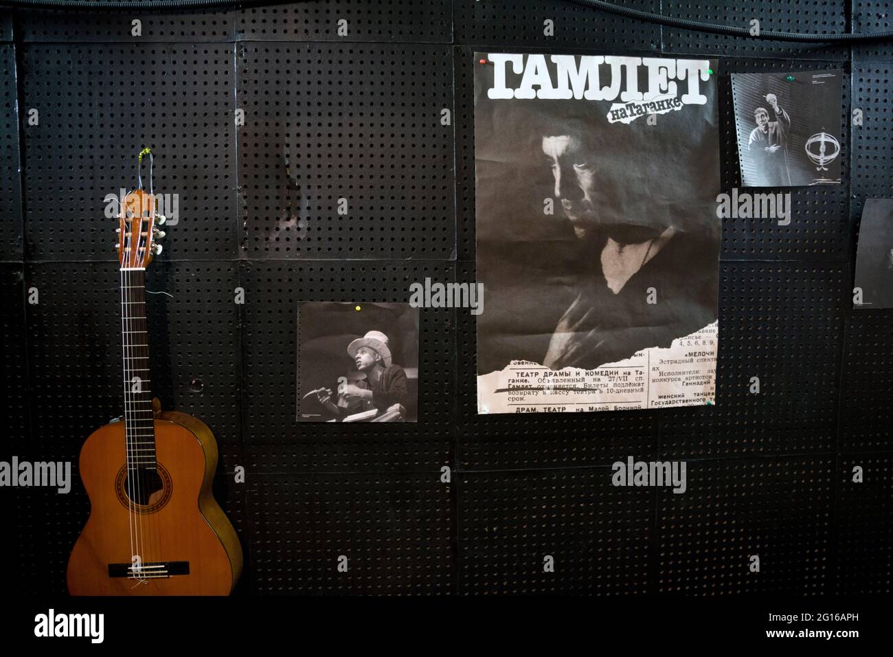Moscow, Russia. 14th of February, 2014 Playbill of the play 'Hamlet' with a photo of Vladimir Vysotsky, guitar and photos from the performances on the wall in the office of the sound engineer of the Taganka Theater Stock Photo