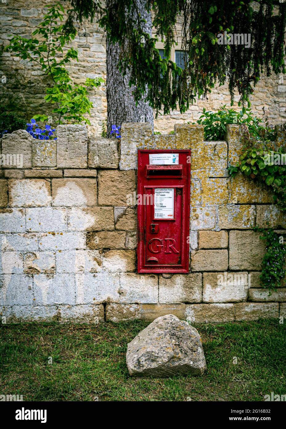 A George VI Royal Mail post box set in the wall of a garden. Stock Photo