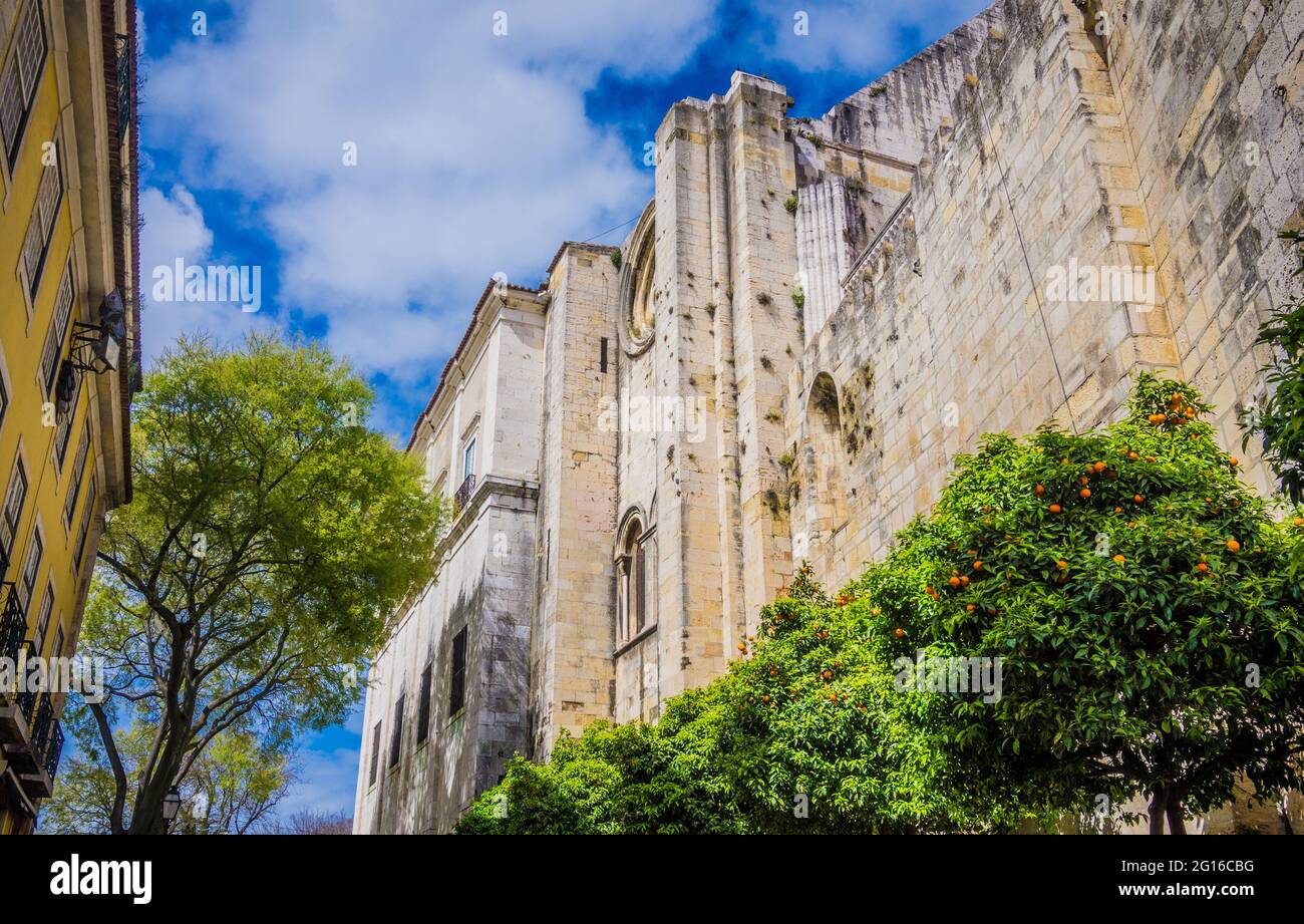 Stone walls of the Castle of St. George, Alfama, Lisbon, Portugal with citrus trees Stock Photo