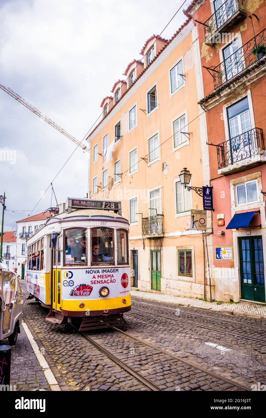 LISBON, PORTUGAL - MARCH 25, 2017: Popular tourist old yellow vintage tram number 28 on the street of Lisbon, Portugal Stock Photo