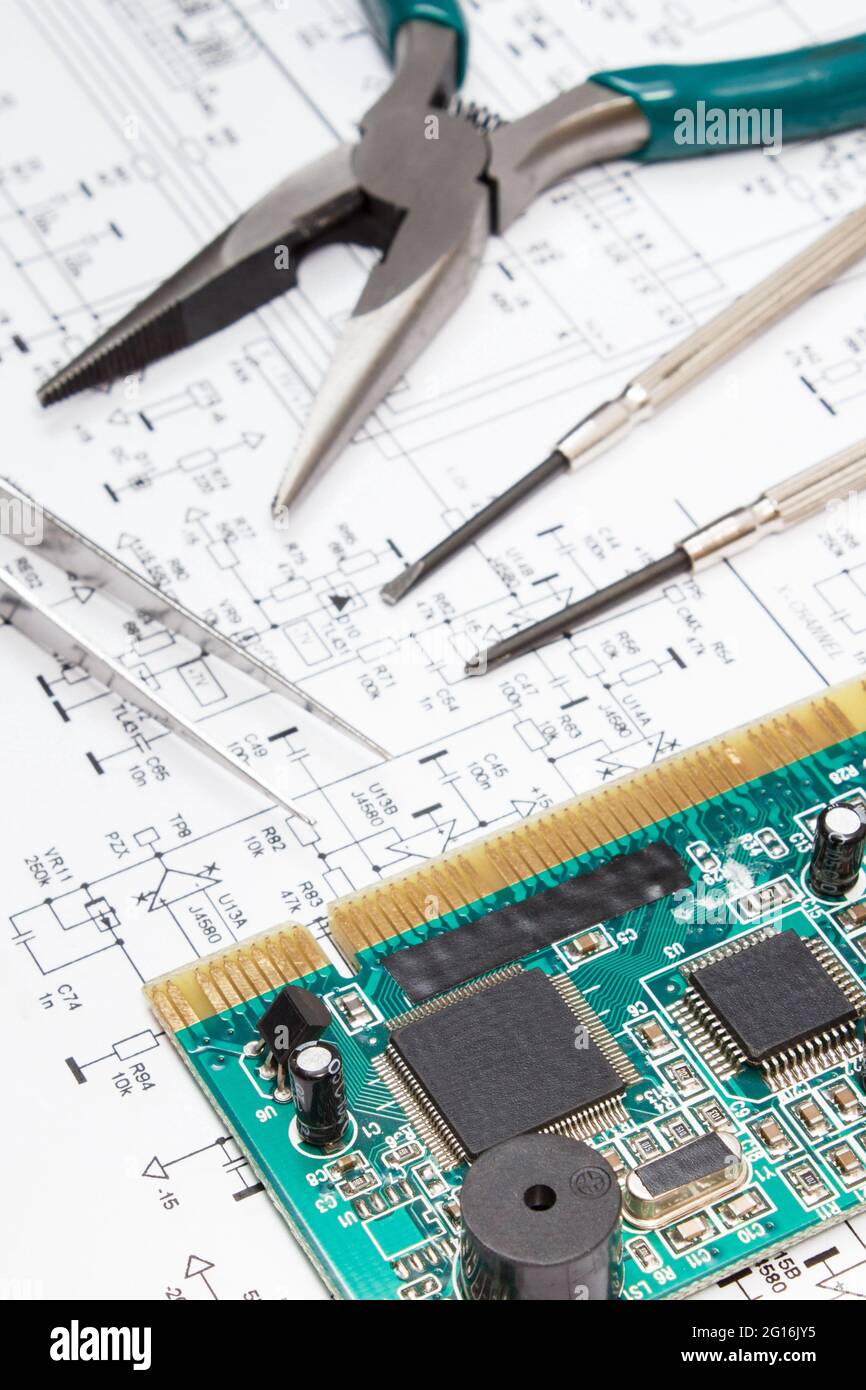 Printed circuit board with transistors, resistors, capacitor. Precision tools and diagram of