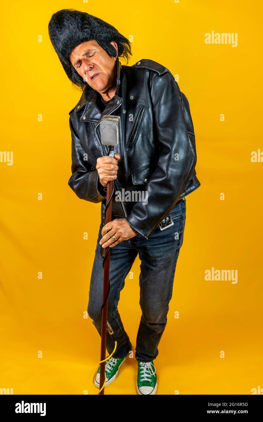 https://c8.alamy.com/comp/2G16R5D/funny-portrait-of-mature-rocker-an-old-singer-dressed-in-rockabilly-style-in-action-mature-man-on-colored-backgrounds-2G16R5D.jpg