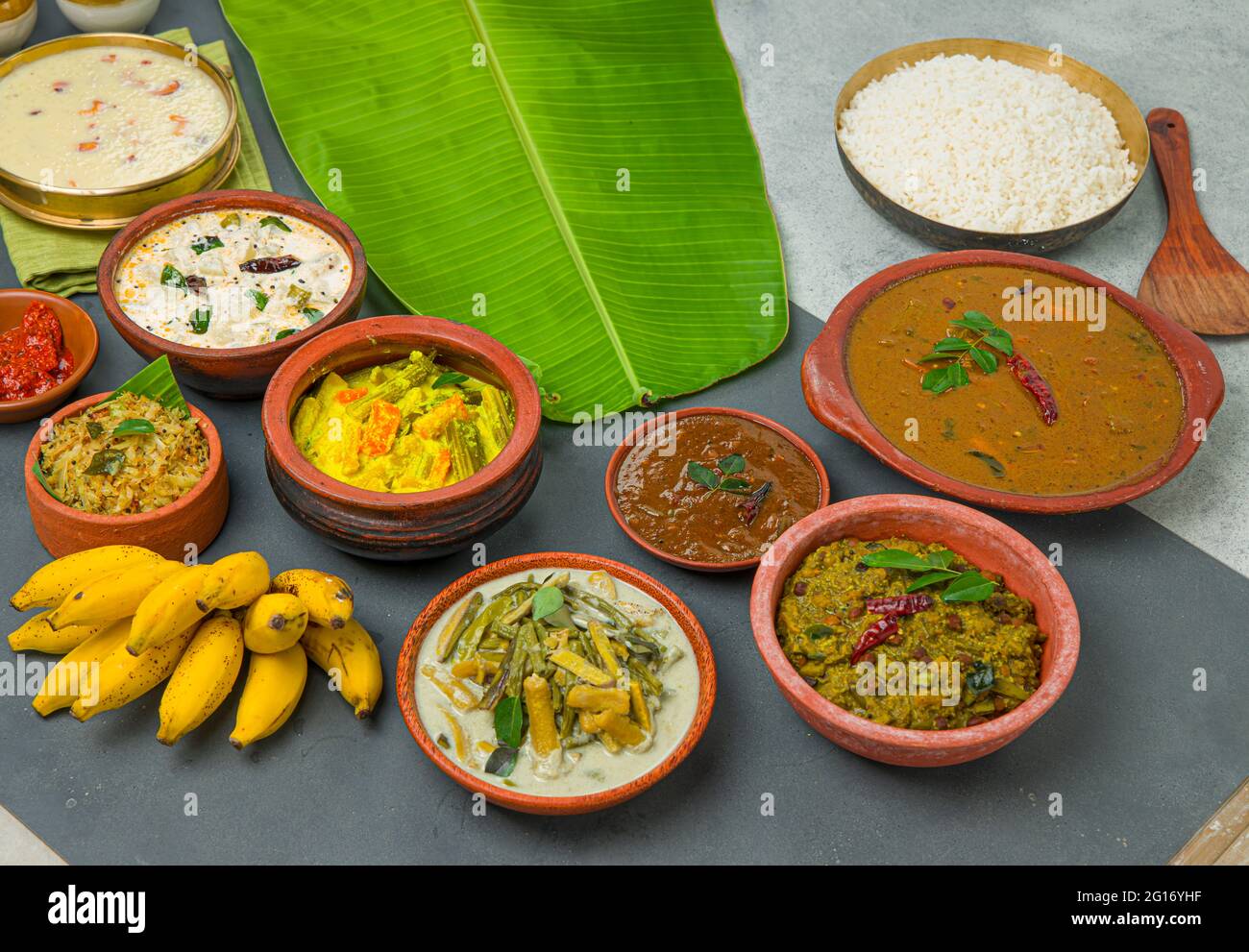 Kerala traditional feast side dishes and cooked rice arranged in a two ...