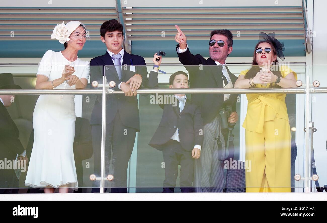 Simon Cowell and Lauren Silverman along with their children Eric and Adam  watch the action with other racegoers during day two of the Cazoo Derby  Festival at Epsom Racecourse. Picture date: Saturday