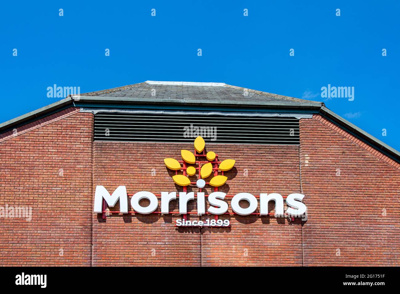 Morrisons since 1899 sign and logo on outside supermarket shop wall UK Stock Photo