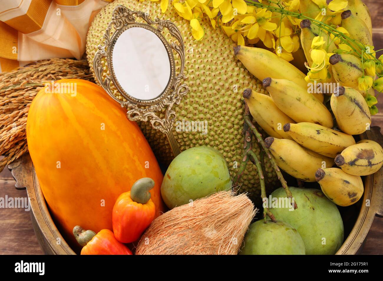 Kerala festival,rituals of Vishu festival -Vishukkani or Vishu sight, a brass vessel  filled with fruits,vegetable, paddy,mirror,golden shower flower Stock Photo