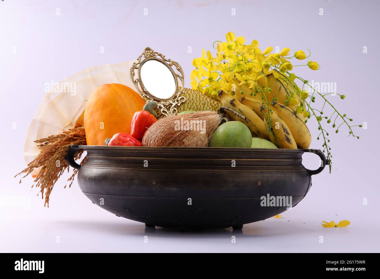 Kerala festival,rituals of Vishu festival -Vishukkani or Vishu sight, a brass vessel  or Urule filled with fruits and vegetables mostly  available in Stock Photo