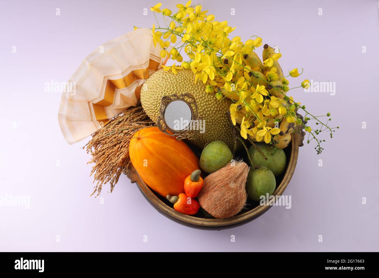 Kerala festival,rituals of Vishu festival -Vishukkani or Vishu sight, a brass vessel  or Urule filled with fruits and vegetables mostly  available in Stock Photo