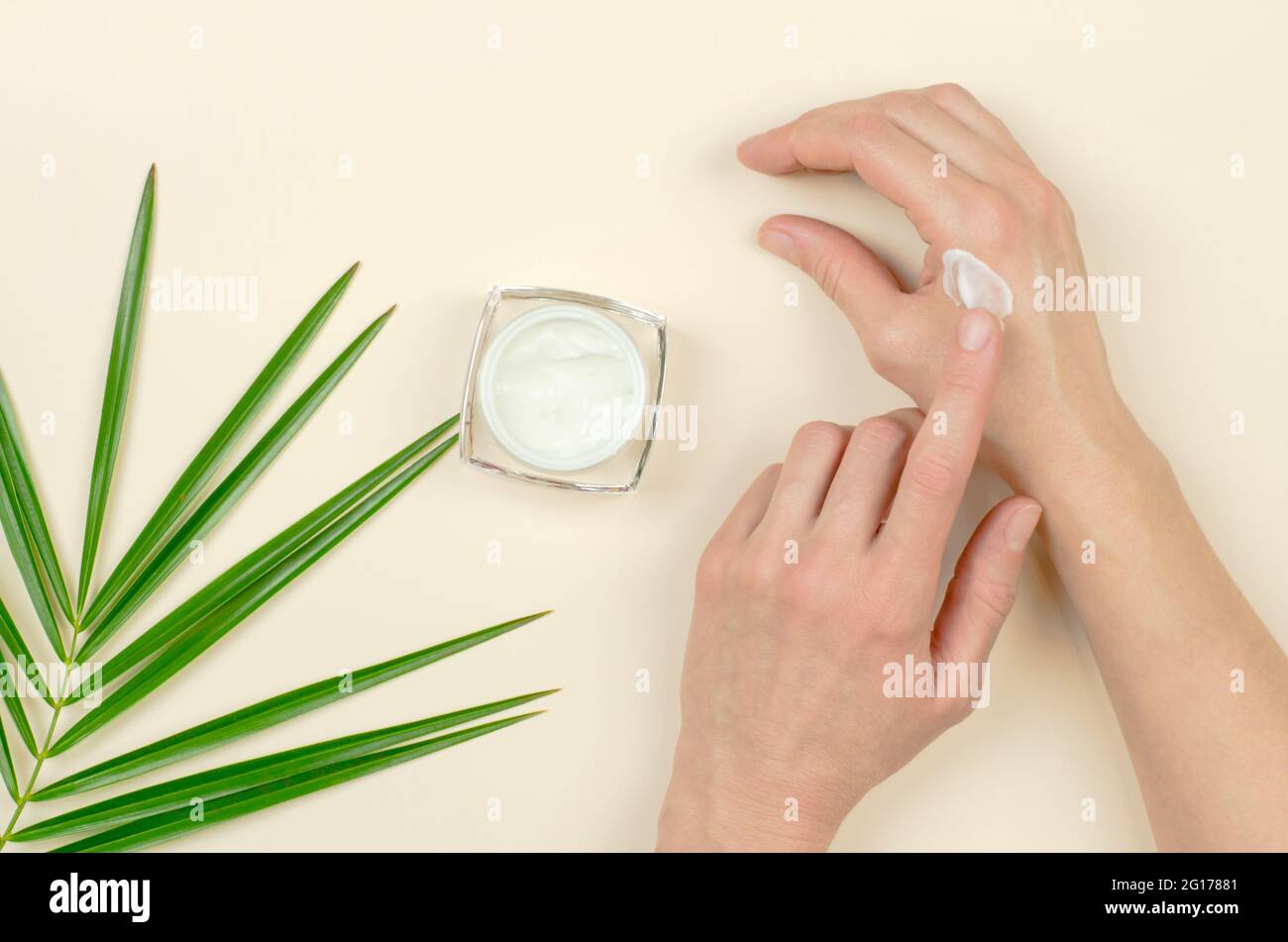 A woman applies moisturizer to hands. Organic cosmetics for skin care. Beauty concept Stock Photo