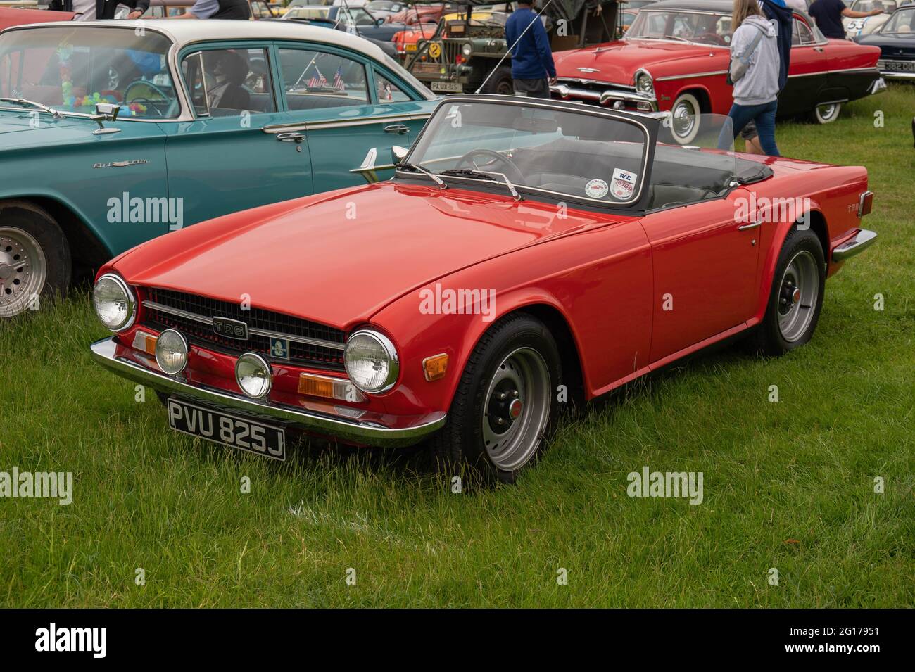 Triumph TR6 in red with spot lights with its roof down at a classic car show Stock Photo