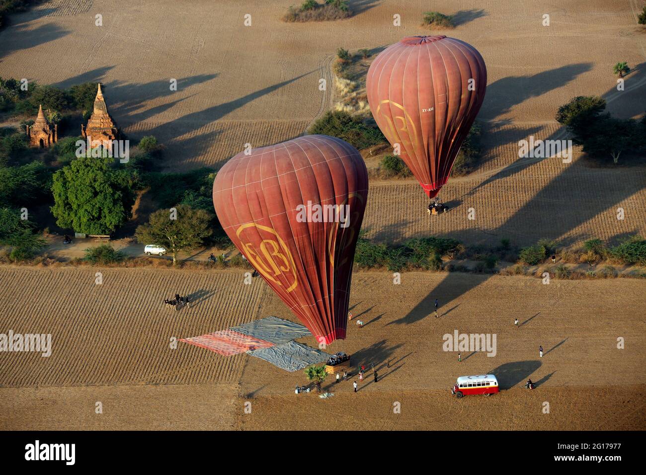Two hot air balloons landing after a tourist flight over the temples of Bagan in Myanmar (Burma). Stock Photo