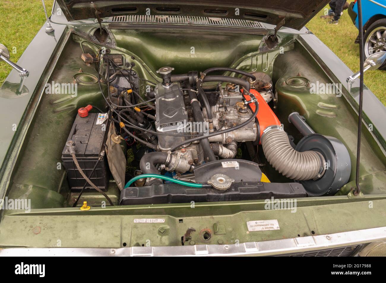 A view of a Holbay H120 engine in a hillman hunter with twin side draft carburettors Stock Photo