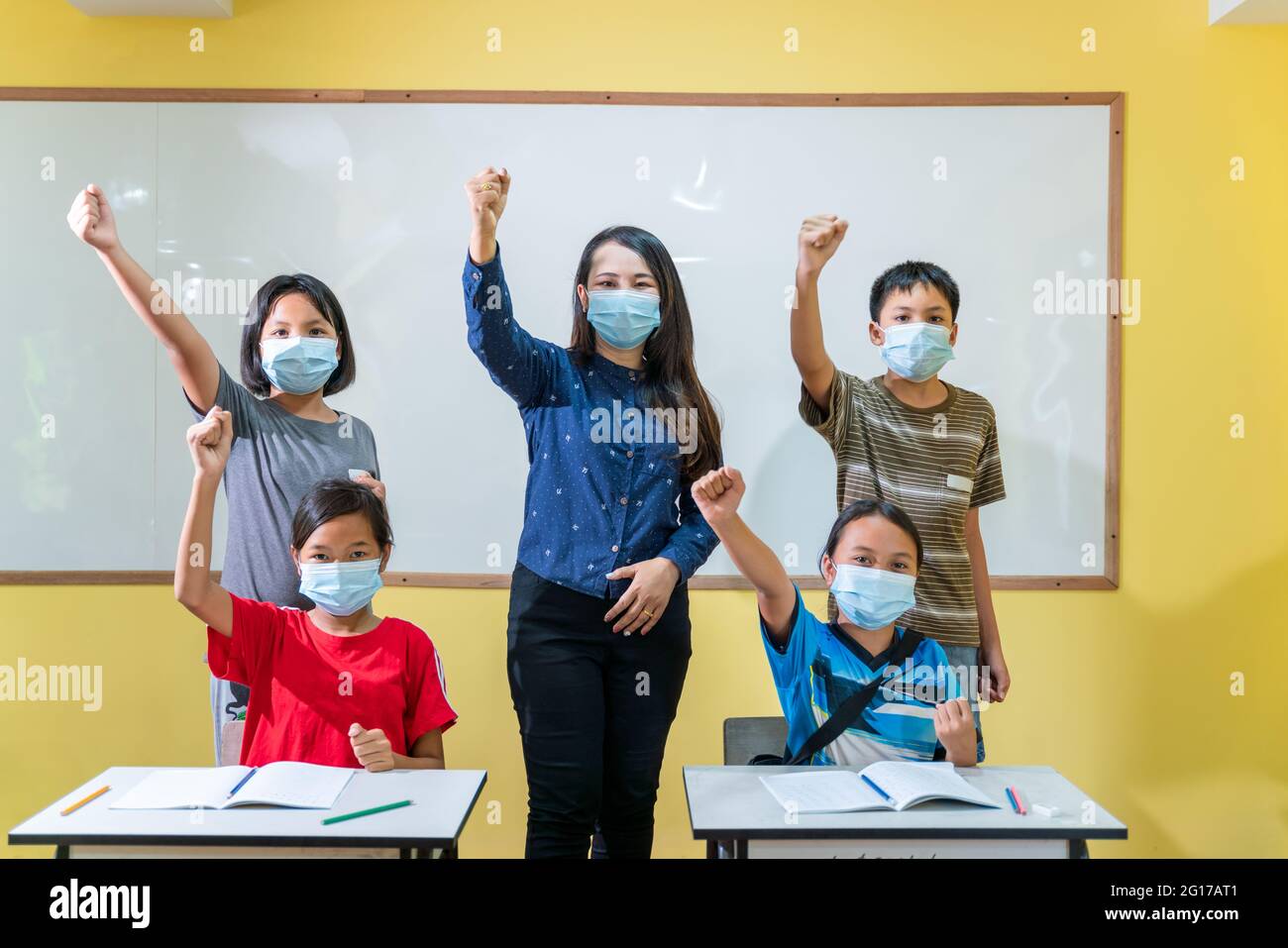 Happy group of asian teacher and children studying in classroom with ...