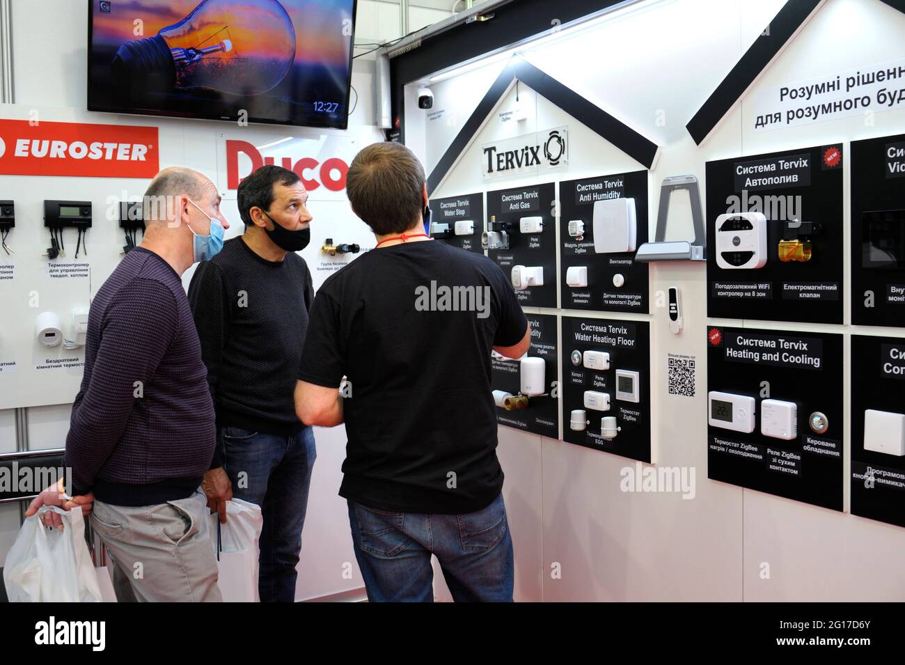 Buyers and seller discuss control systems of electricity, heating and  security for smart houses presented on stand. Exhibition Install fest  Ukraine. J Stock Photo - Alamy