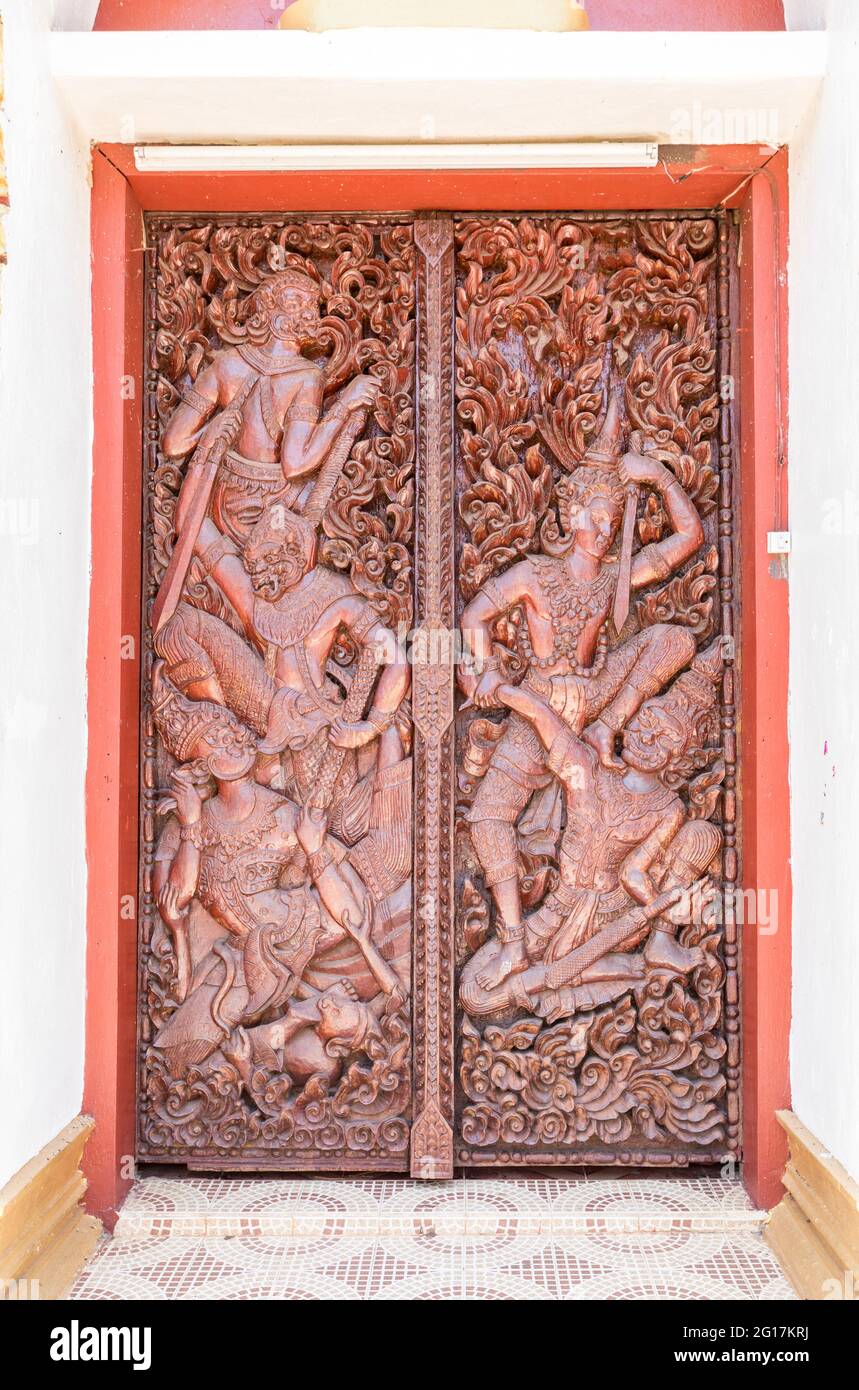Carved figures in door to Wat Luang Pakse, temple in Pakse, Laos Stock Photo