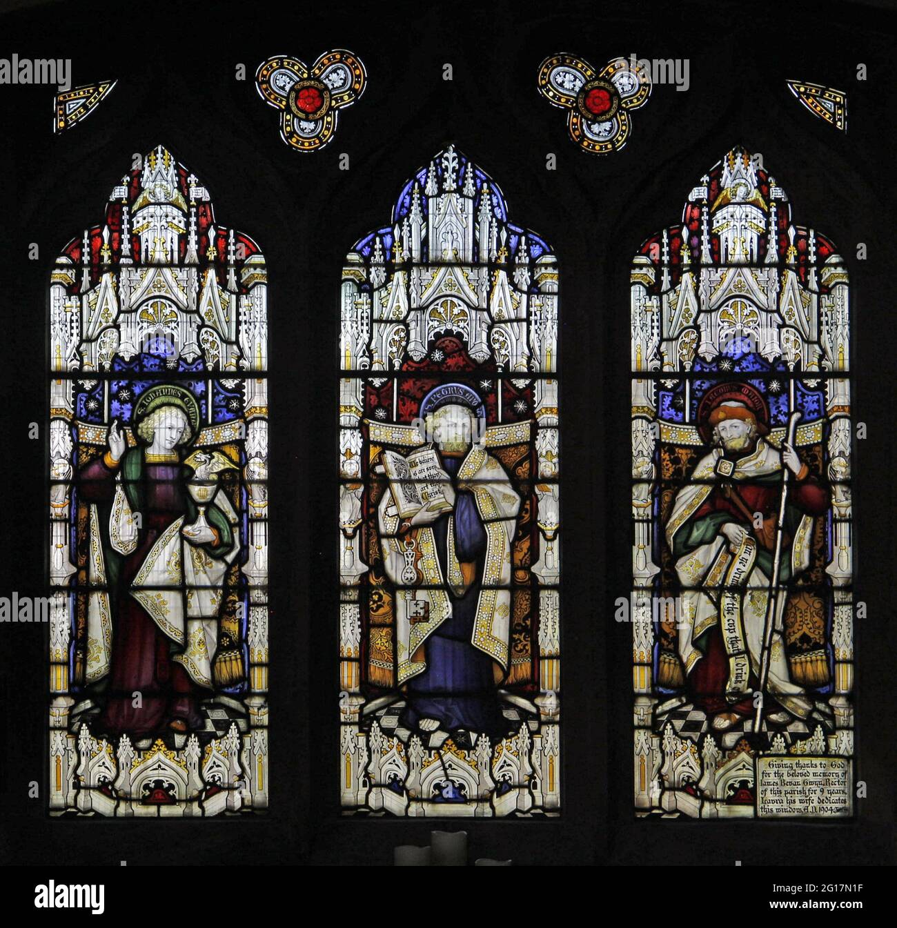 Stained glass window by Herbert Bryans depicting St John, St Peter and St James the Great, St Leonard's Church, Rockingham, Northamptonshire Stock Photo