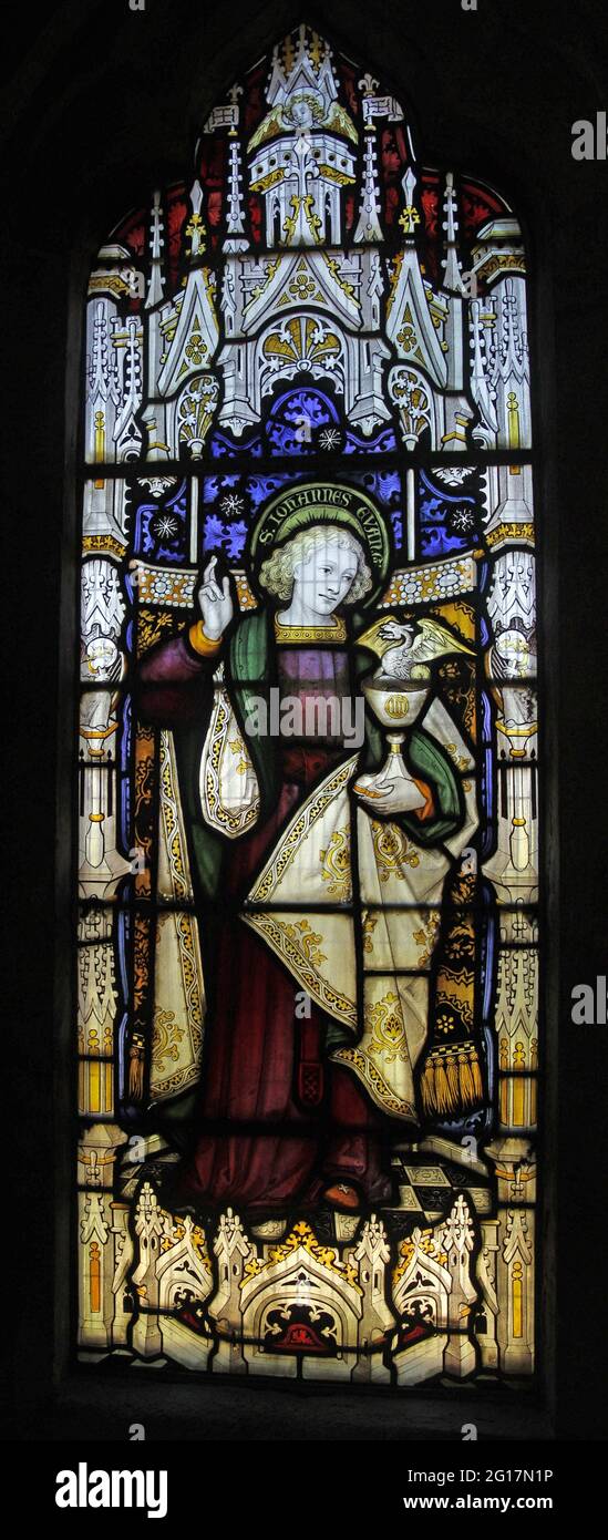 Stained glass window by Herbert Bryans depicting St John, St Leonard's Church, Rockingham, Northamptonshire Stock Photo