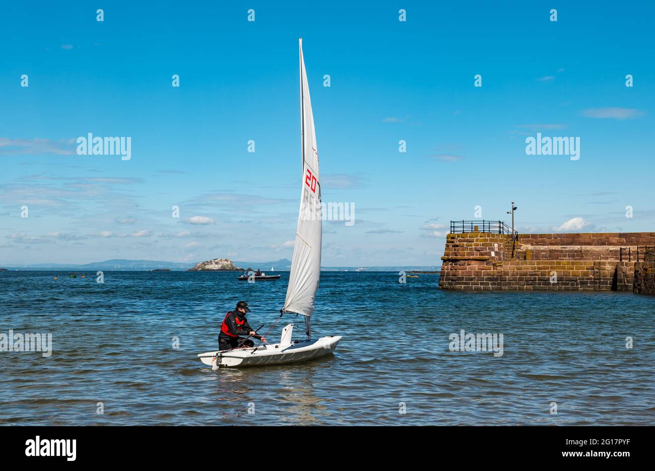 Sailing dinghy in West Bay in Summer sunshine, North Berwick, East Lothian, Scotland, UK Stock Photo