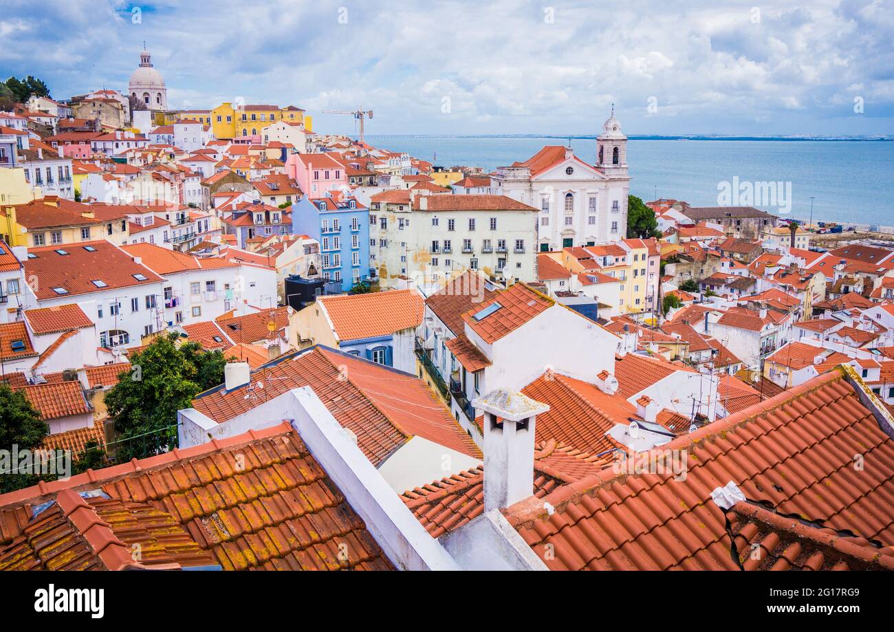 LISBON, PORTUGAL - MARCH 25, 2017: Panoramic view old traditional city of Lisbon with red roofs, Saint Vicente de Fora Monastery view, Alfama district Stock Photo