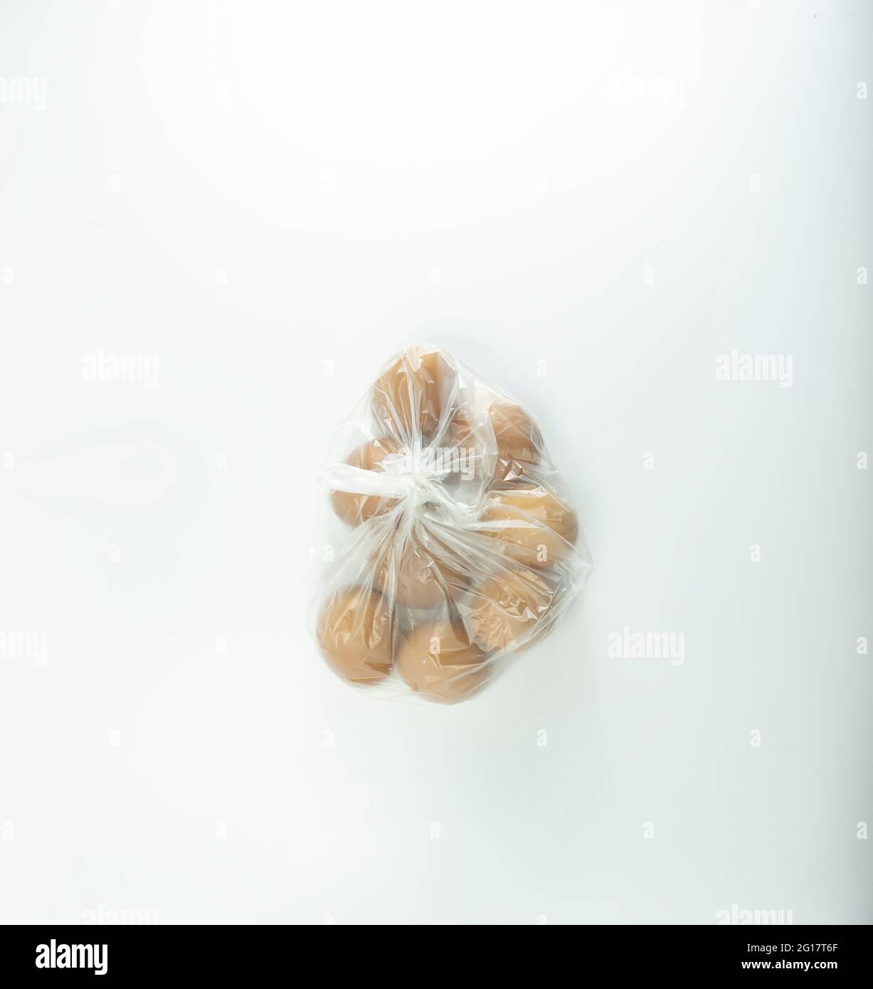 Chicken eggs wrapped in transparent white plastic. Stock Photo