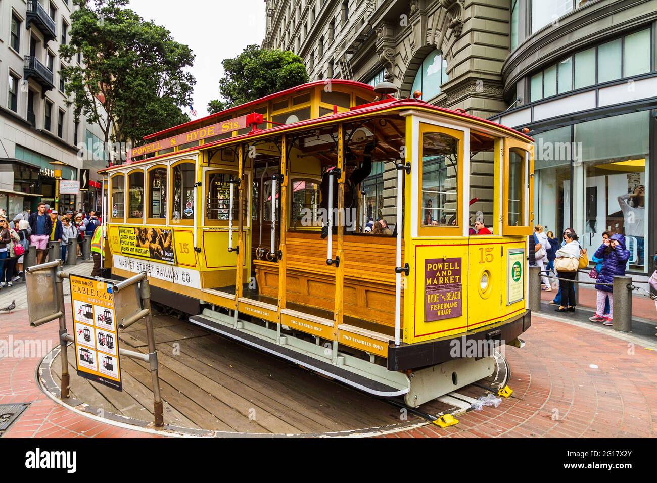 A cable car on turntable and tourists waiting for a ride in San Francisco Stock Photo