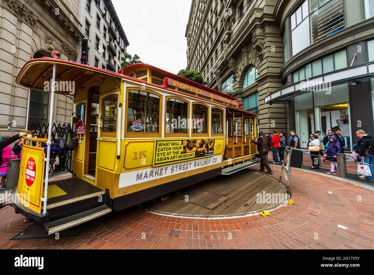 People waiting to take the cable car while it is being rotated by the