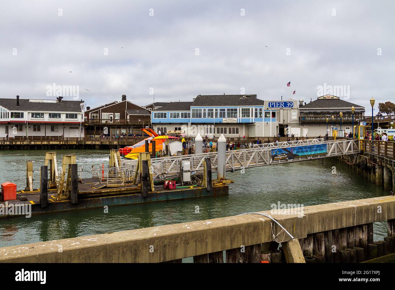 View of Pier 39 in San Francisco on a cloudy day with many tourists Stock Photo