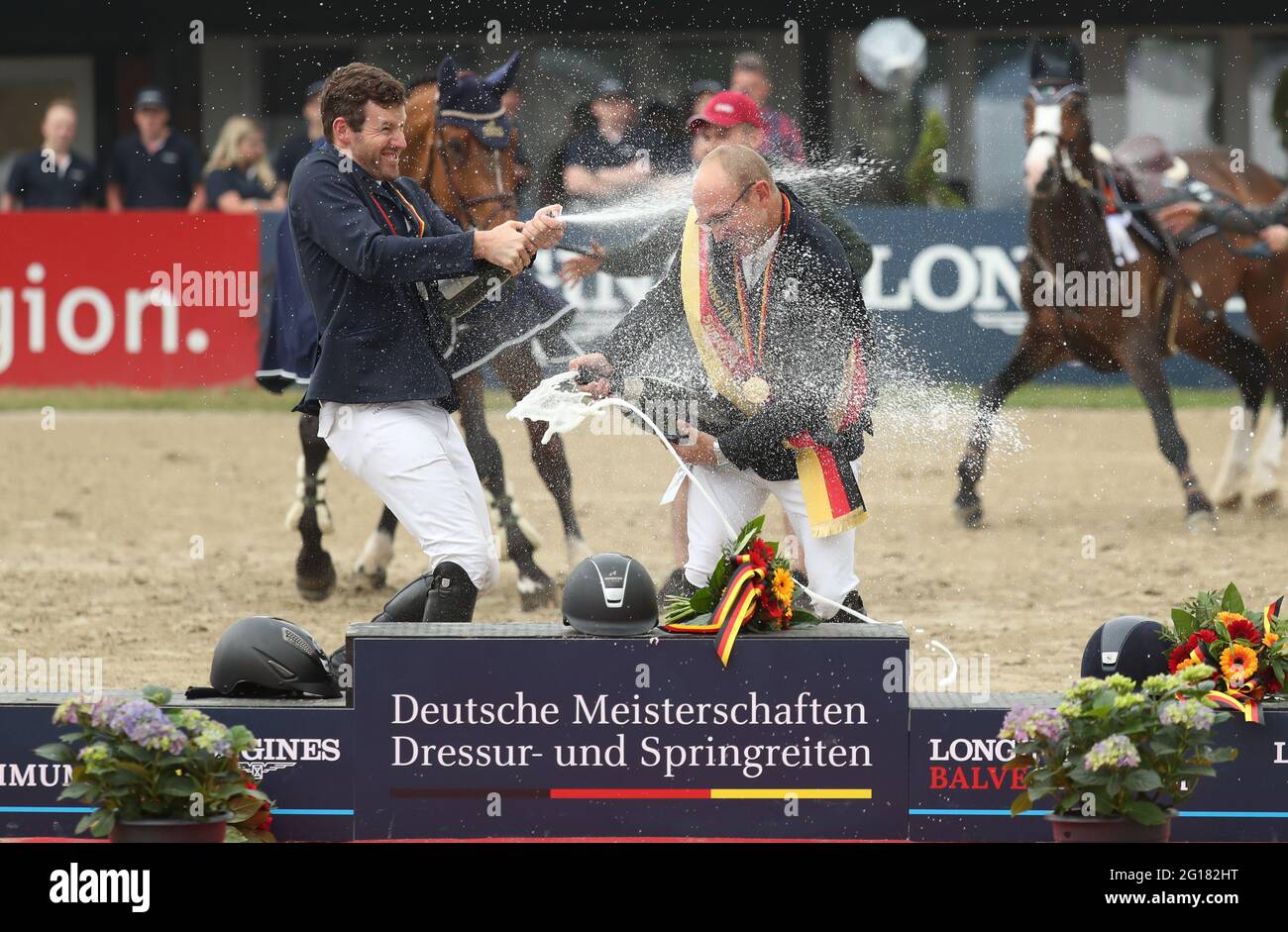 Balve, Germany. 05th June, 2021. Equestrian sport: German championship, show jumping. The show jumper Tobias Meyer (r) celebrates winning the German Show Jumping Championship with the runner-up Maximilian Weishaupt (l). Credit: Friso Gentsch/dpa/Alamy Live News Stock Photo