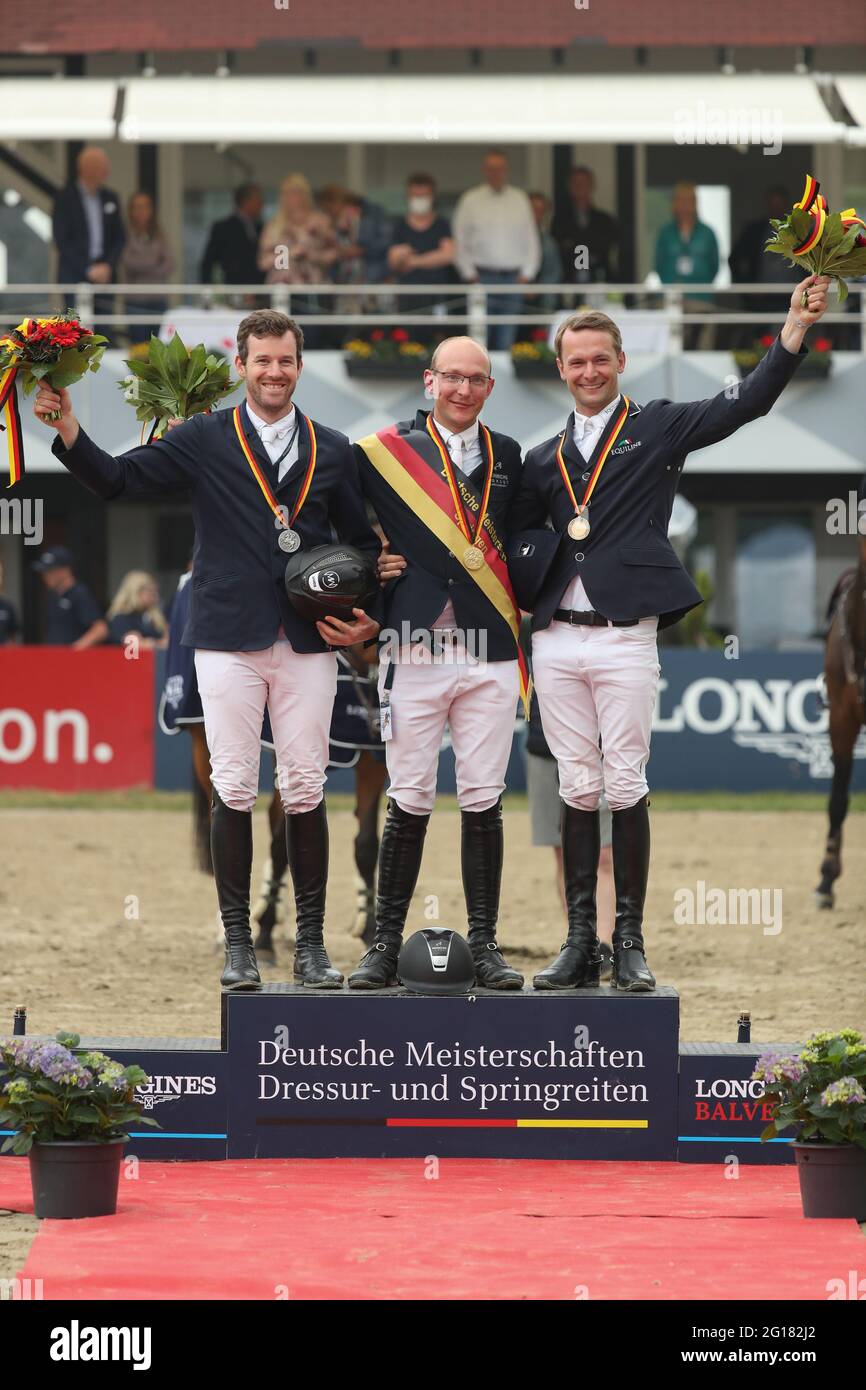 Balve, Germany. 05th June, 2021. Equestrian sport: German championship, show jumping. The show jumper Tobias Meyer (M) wins on Greatest Boy - H at the German Show Jumping Championships. Second place goes to Maximilian Weishaupt (l) and third place to Patrick Stühlmeyer (r). Credit: Friso Gentsch/dpa/Alamy Live News Stock Photo