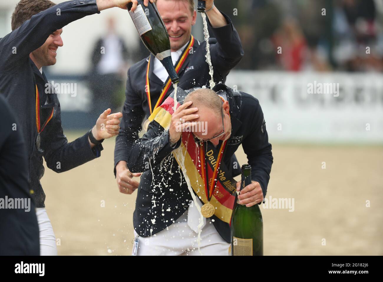 Balve, Germany. 05th June, 2021. Equestrian sport: German championship, show jumping. The show jumper Tobias Meyer (r) celebrates winning the German Show Jumping Championship with the second placed Maximilian Weishaupt (l) and the third placed Patrick Stühlmeyer (M). Credit: Friso Gentsch/dpa/Alamy Live News Stock Photo