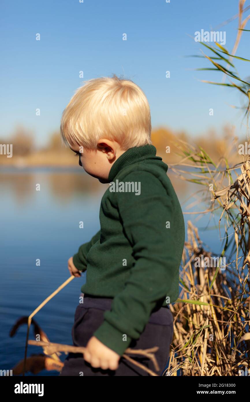 A little boy that is standing in the water Stock Photo