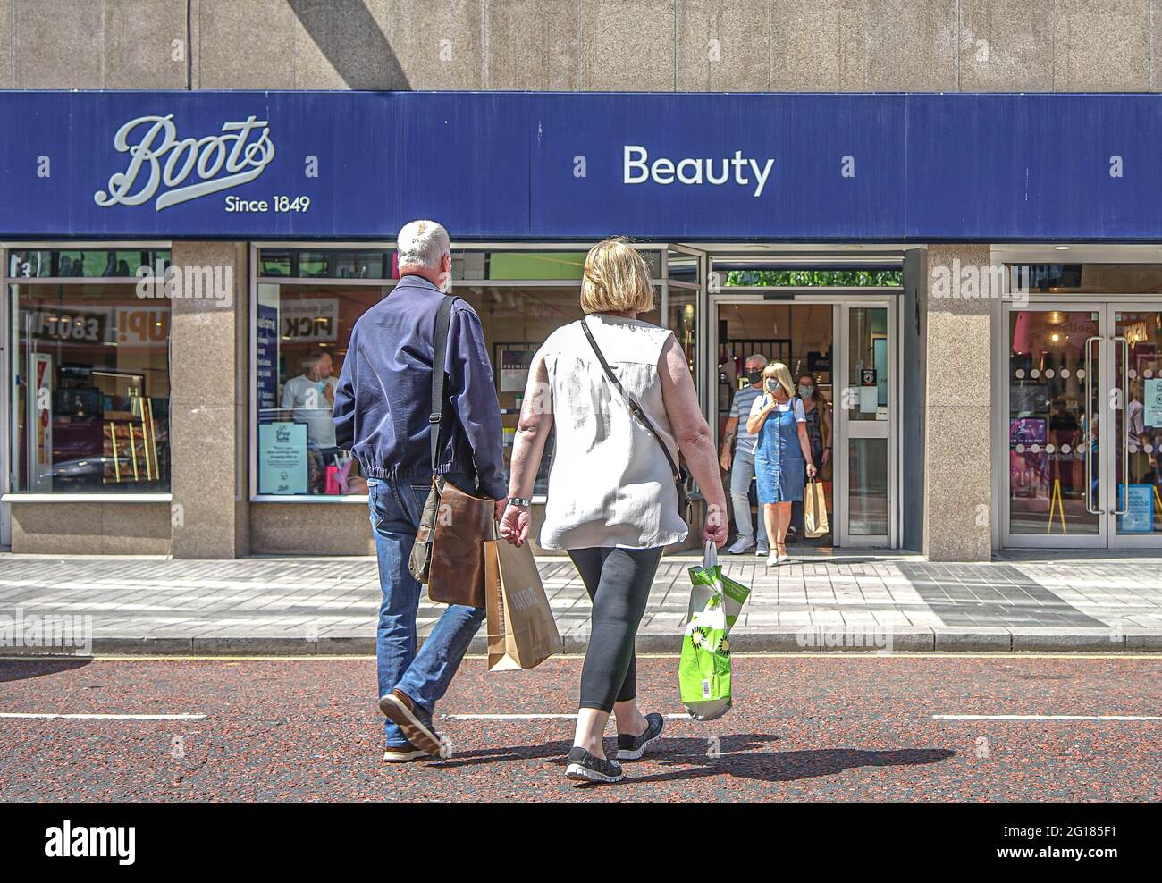 Couple walks towards Boots Pharmacy on Royal Avenue in Belfast. (Photo by  Michael McNerney / SOPA Images/Sipa USA Stock Photo - Alamy