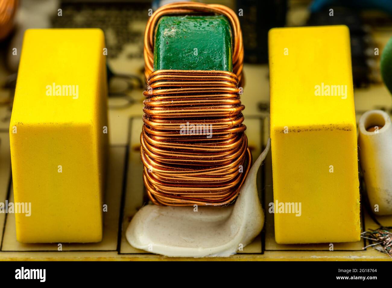 An inductor, toroidal coil on a ring with visible copper scroll, wound on a magnetic coil. Stock Photo