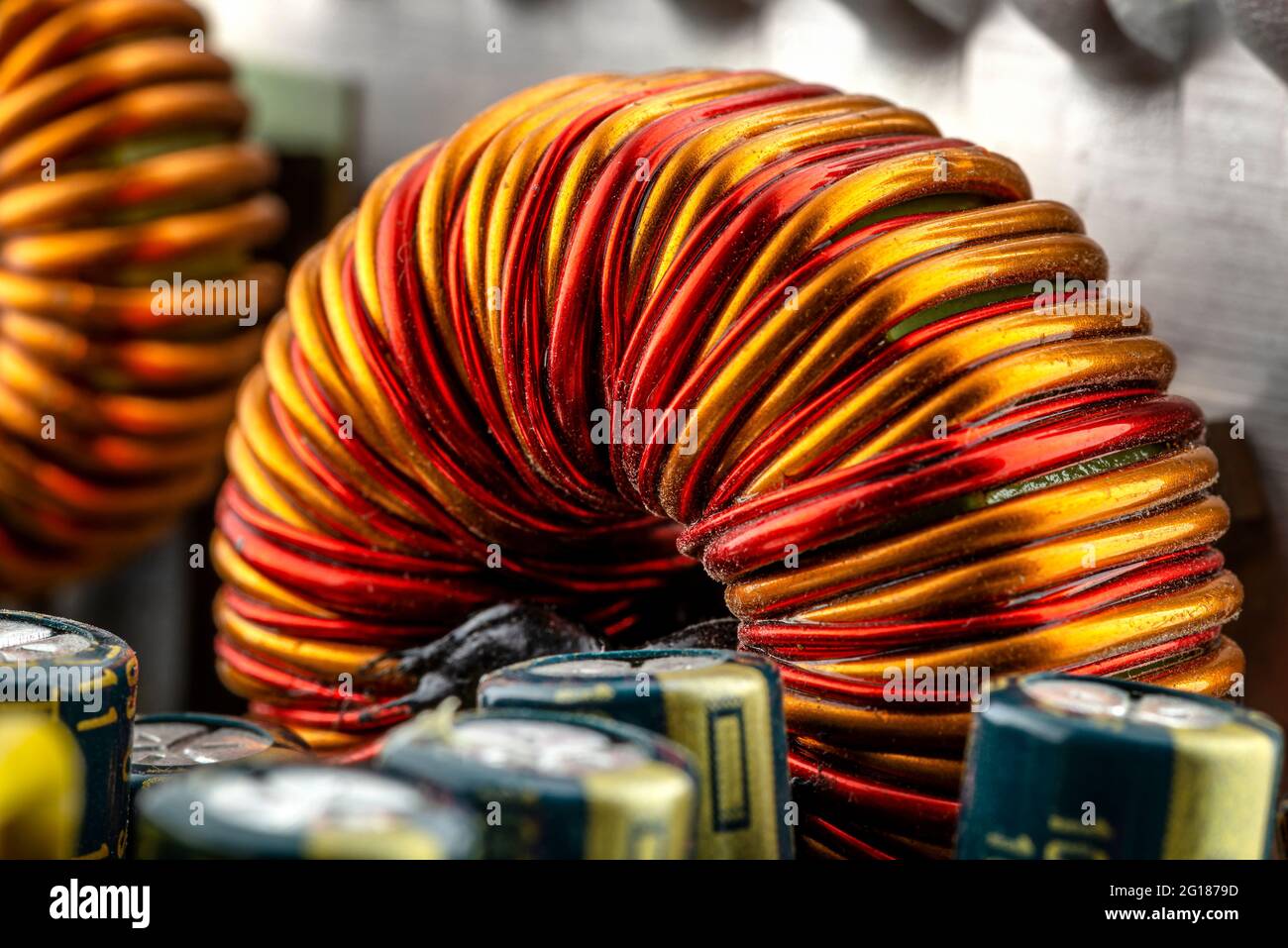 An inductor, toroidal coil on a ring with visible copper scroll, wound on a magnetic coil. Stock Photo