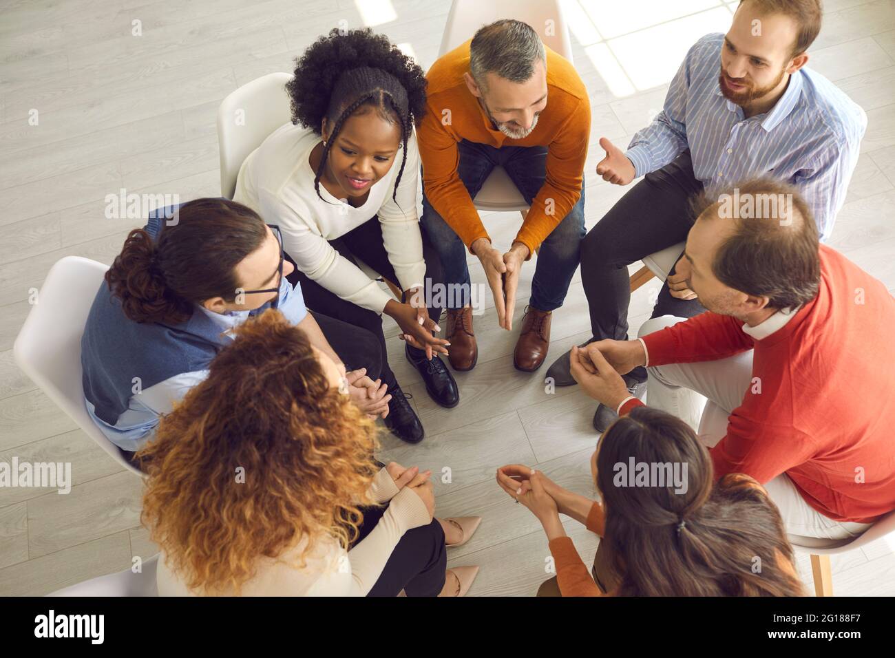Diverse patients talking in friendly positive atmosphere of group therapy session Stock Photo