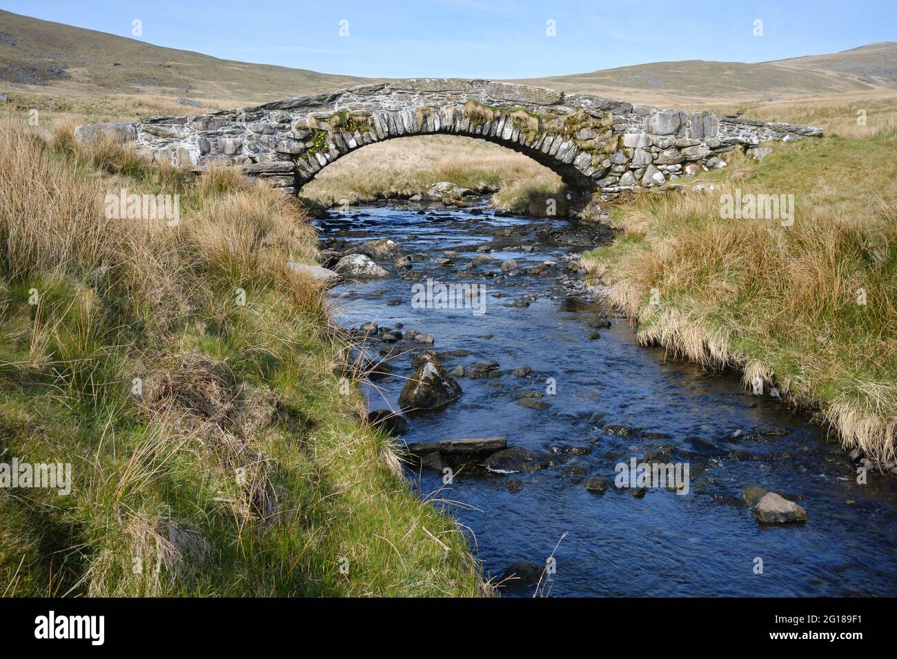 arched bridge over a moorland river Stock Photo