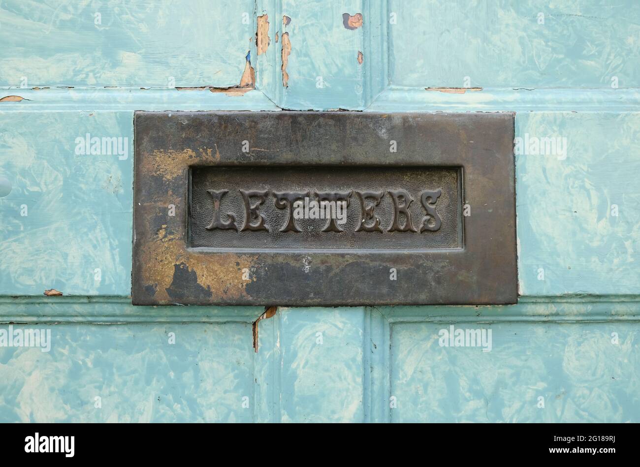 old-fashioned letter box in a the front door of a house Stock Photo