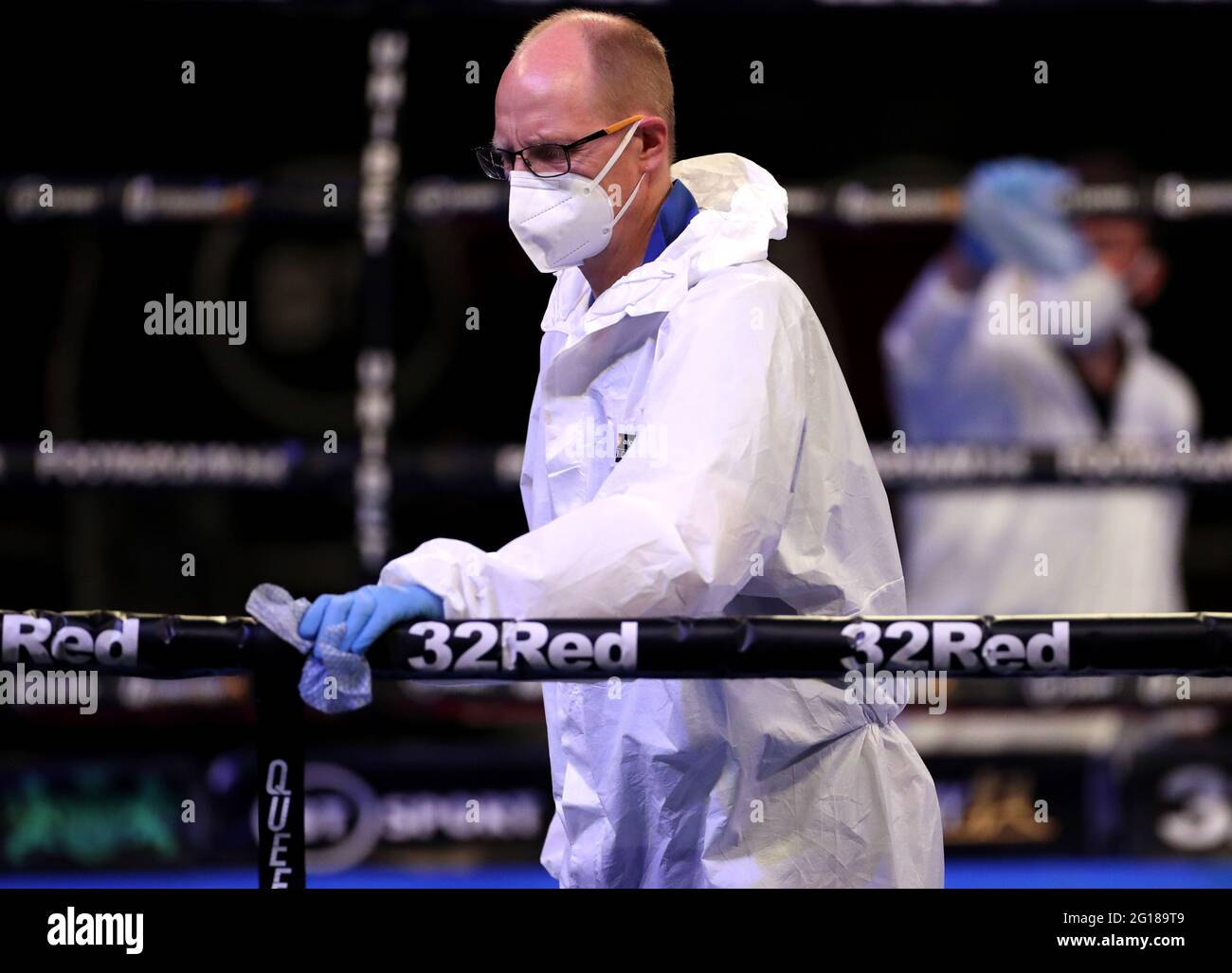 Stewards in PPE disinfect the ring during the Boxing event at the Telford International Centre, Telford. Picture date: Saturday June 5, 2021. Stock Photo