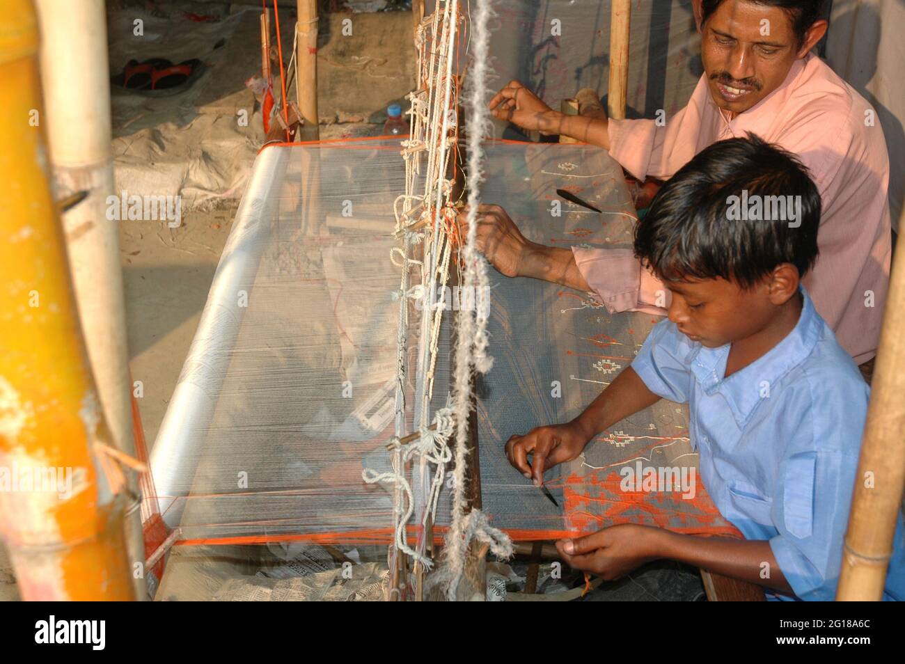 The weaving of Jamdani saree. Jamdani is a superfine handloom fabric which has evolved through generations of outstanding craftsmanship. The designs in the jamdani are geometrical. Sonargaon, Dhaka, Bangladesh. February 1, 2008. Stock Photo