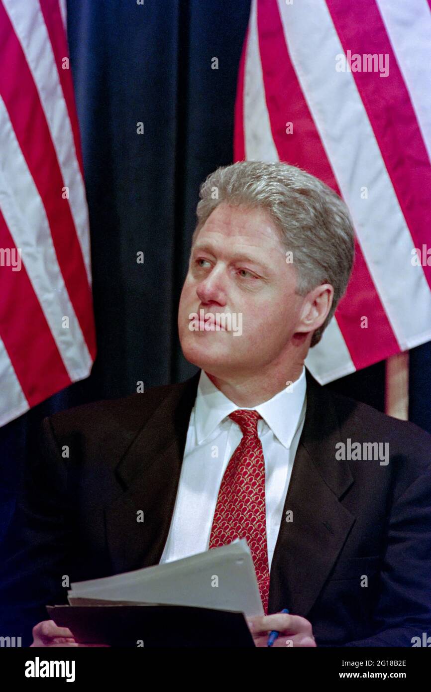 U.S. President Bill Clinton listens to speakers during a signing event announcing the “One