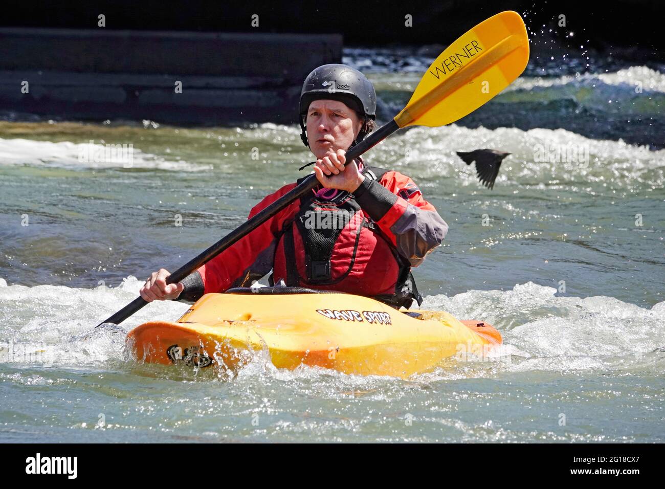 A senior citizen kayaker negotiates the rapids on the Deschutes River in Bend, Oregon. Stock Photo