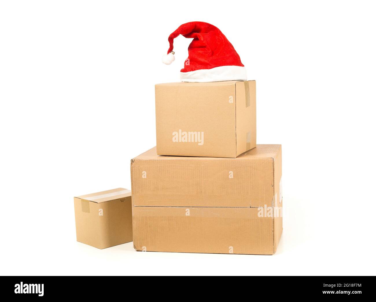 Stack or heap of brown carton cardboard boxes with red santa hat over white  background, christmas shopping or online ordering concept Stock Photo -  Alamy