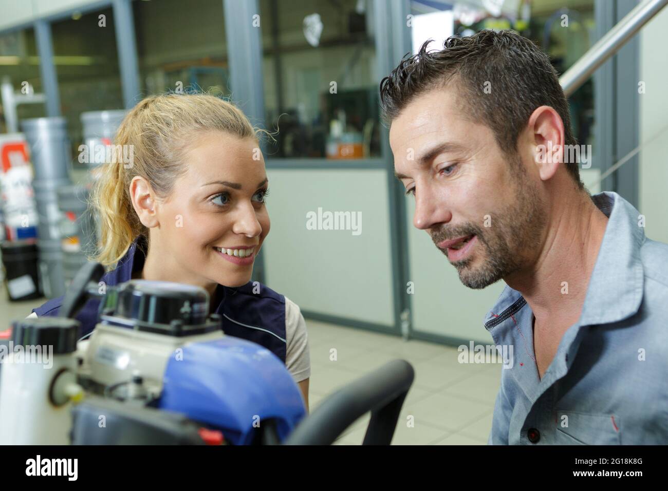 warehouse manager talking to female worker Stock Photo